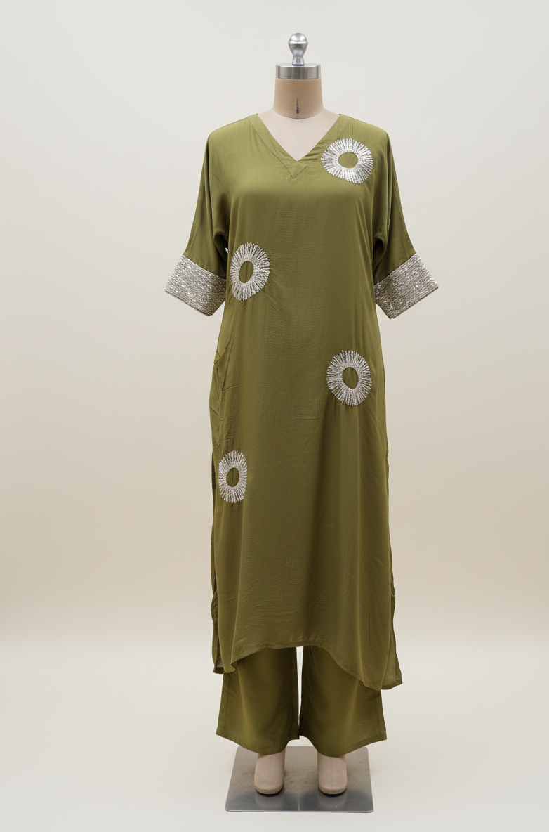 Green dress with white floral patterns on a mannequin against a white background