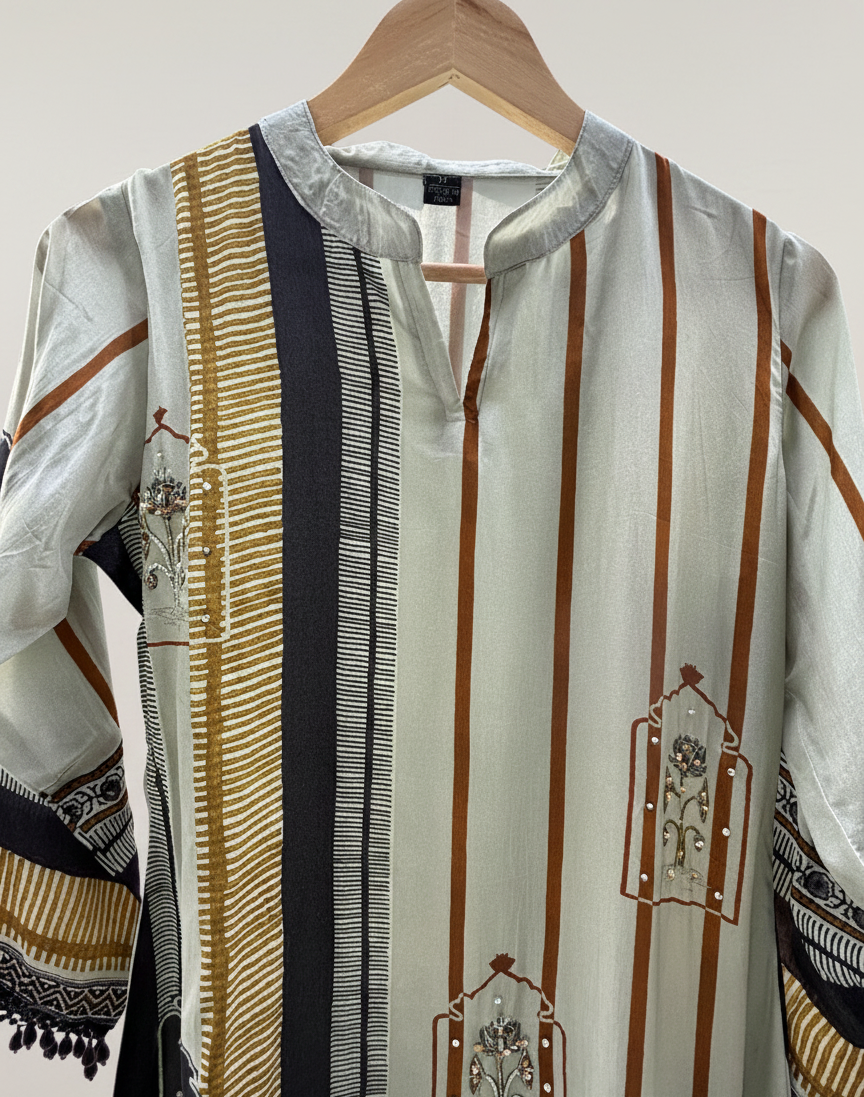 Traditional embroidered shirt on a hanger with a plain background