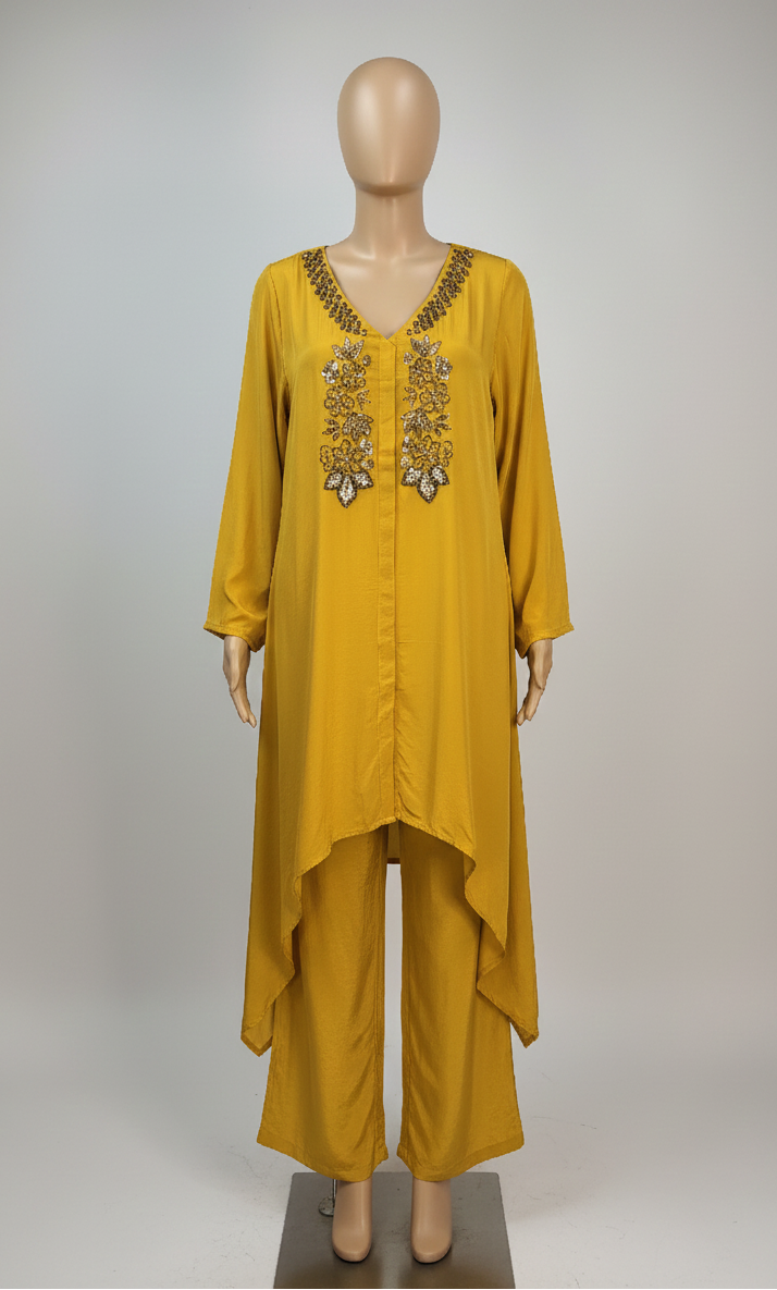 Yellow outfit with embroidery on a mannequin against a gray background