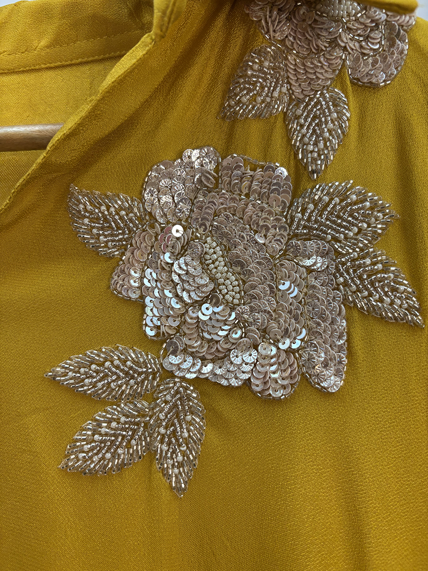 Mustard yellow fabric with silver floral sequin embroidery