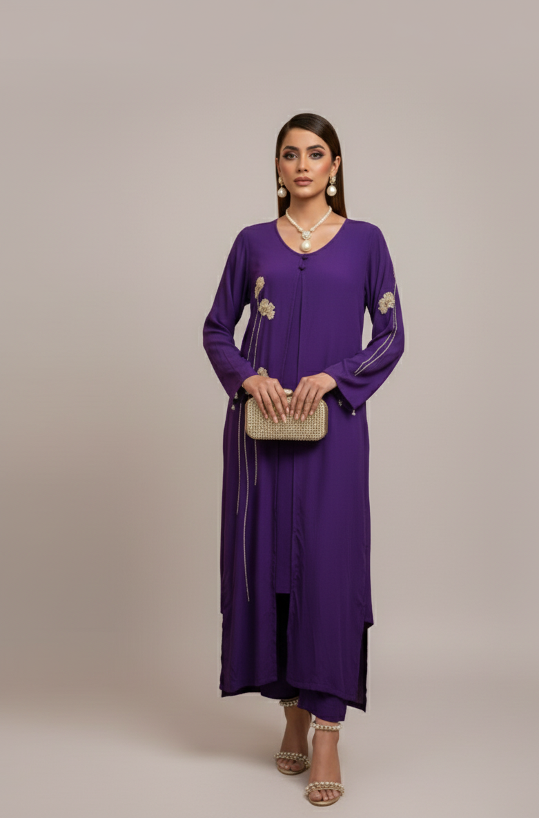 Woman wearing a purple dress with gold accents on a neutral background