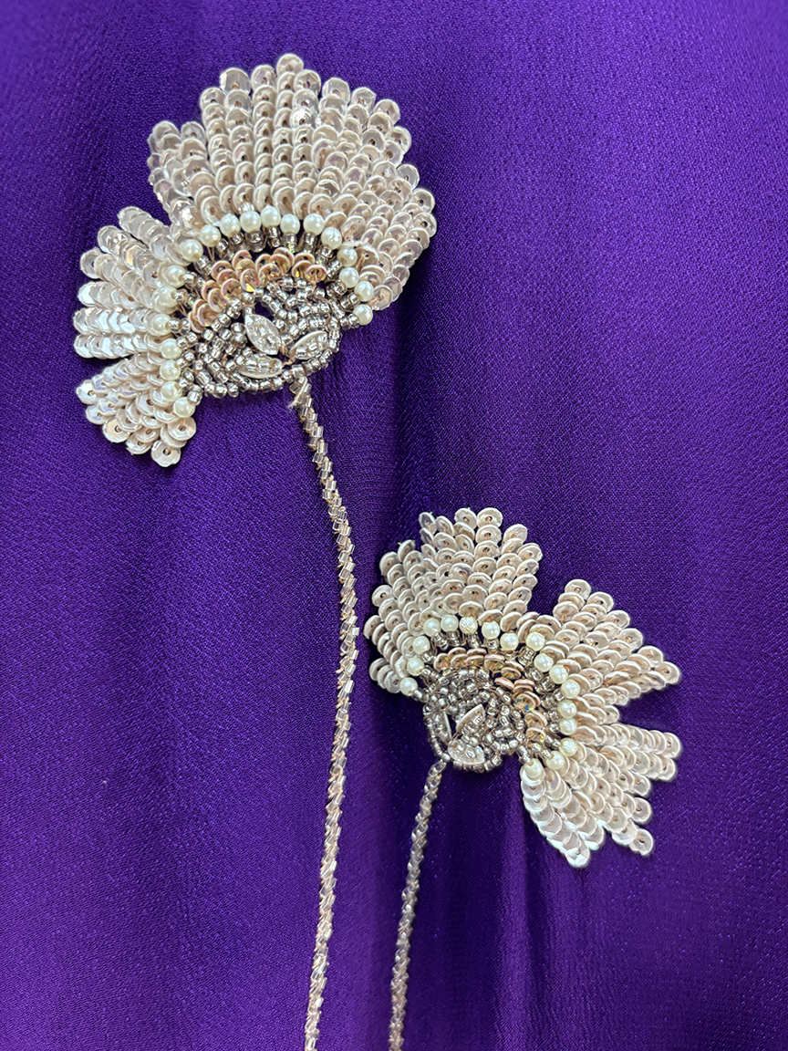 Decorative flower with beads on a purple background
