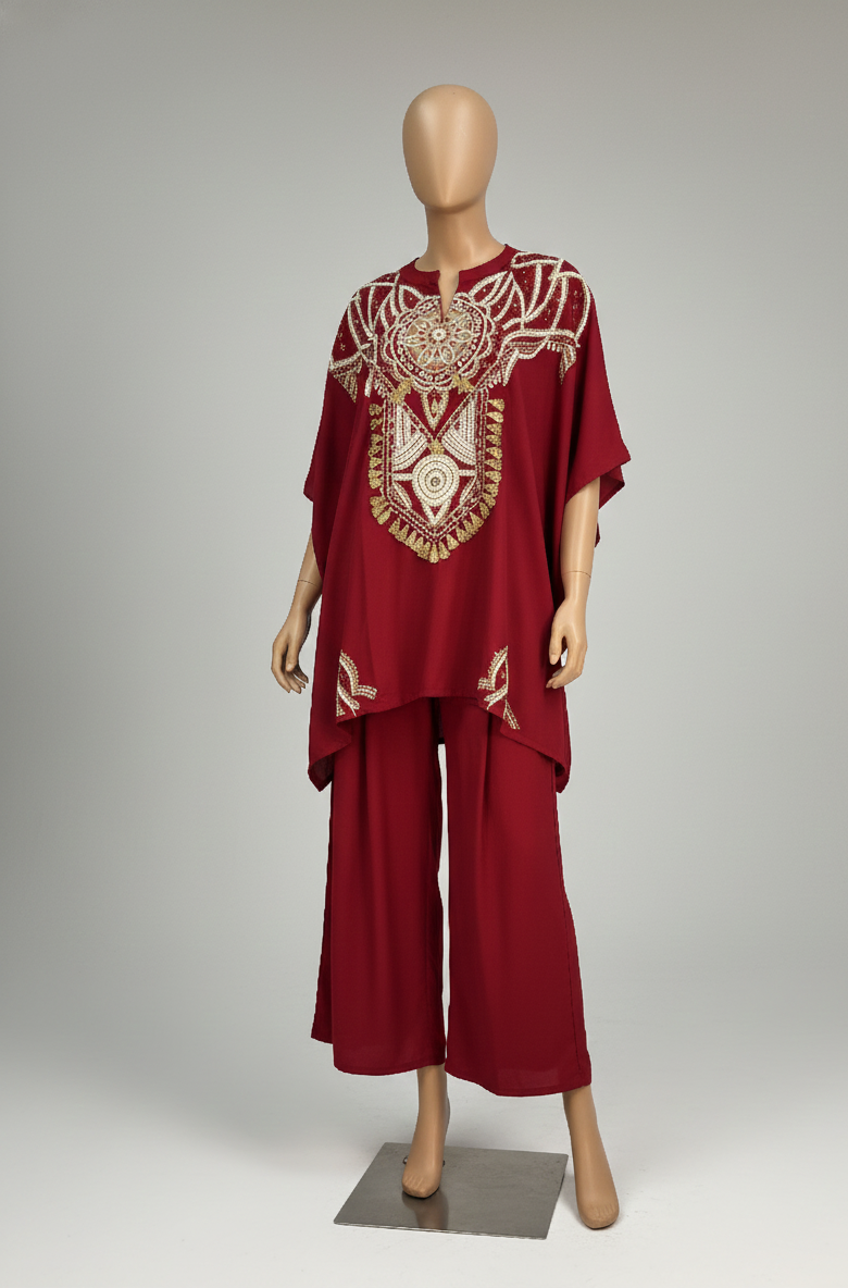 Red outfit with gold embroidery on a mannequin against a gray background