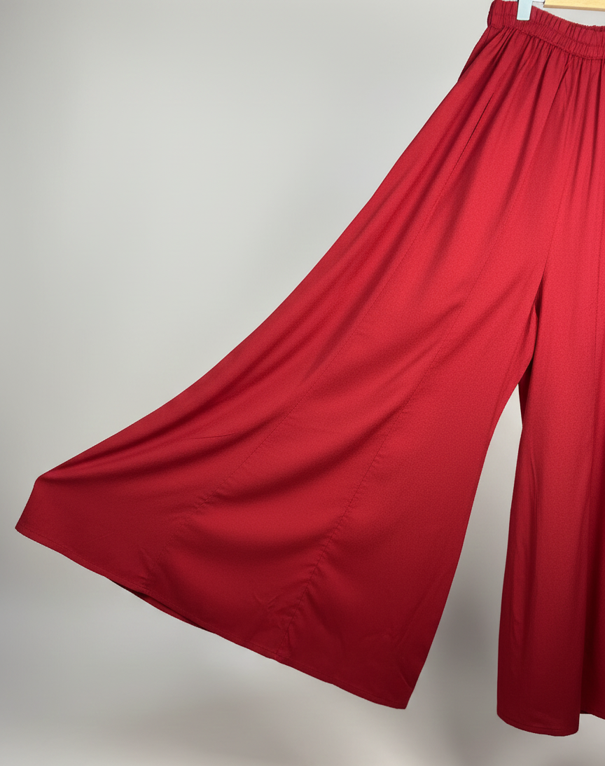 Red wide-leg pants on a light gray background