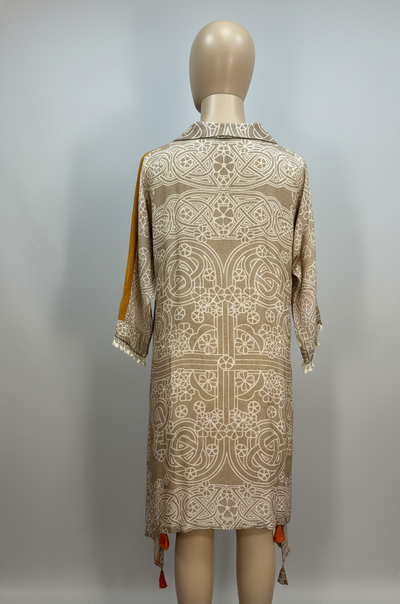 Mannequin wearing a patterned dress with a plain background