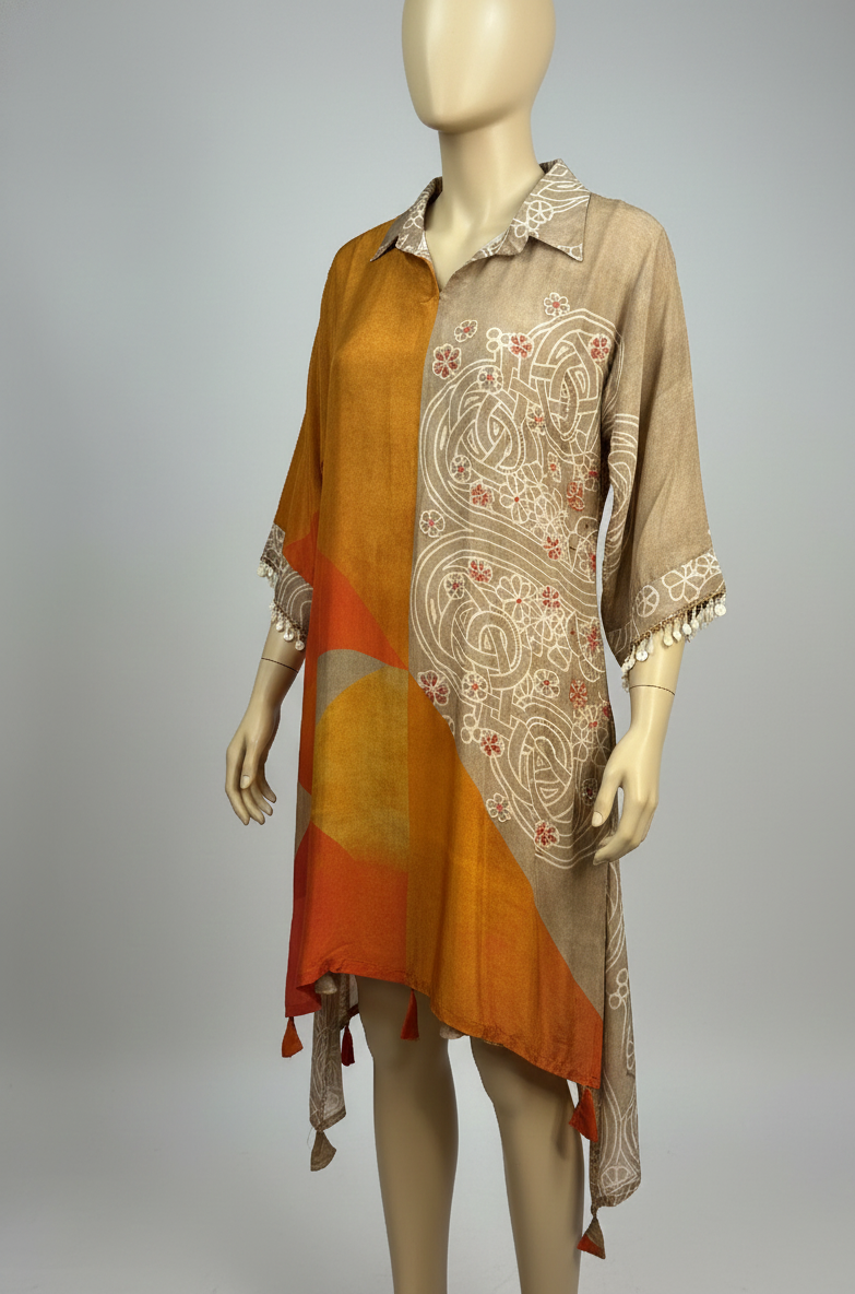 Mannequin wearing a long, patterned scarf with orange and beige colors on a gray background