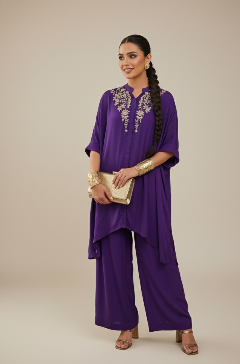 Woman wearing a purple outfit with gold embroidery on a beige background