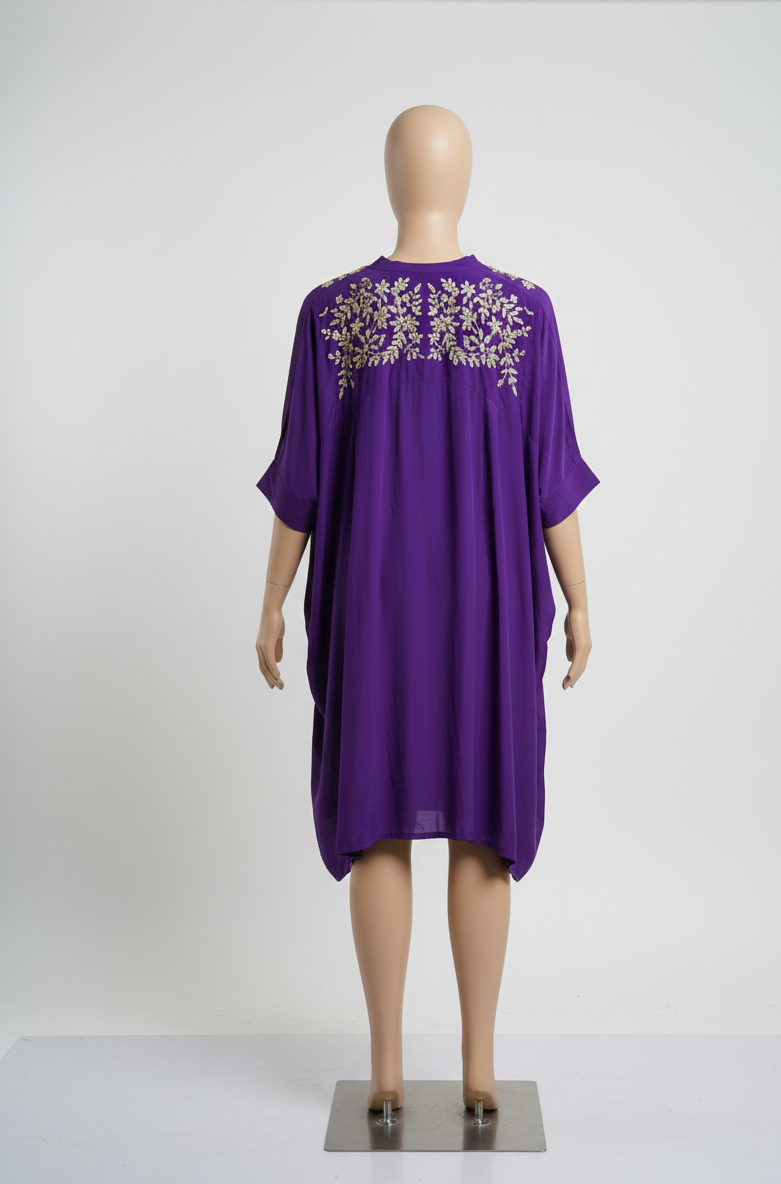 Purple dress with floral embroidery on a mannequin against a white background