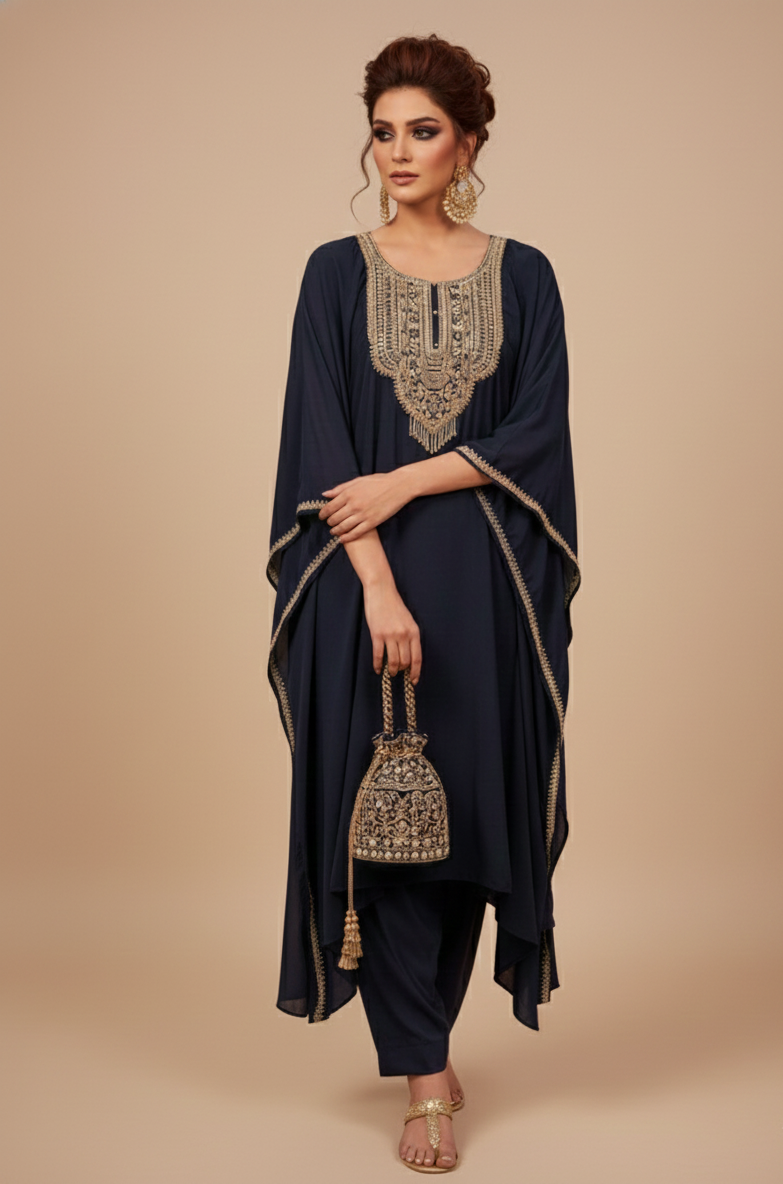 Woman wearing a navy blue outfit with gold embroidery against a beige background