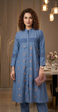 Woman wearing a blue embroidered kurta in an indoor setting