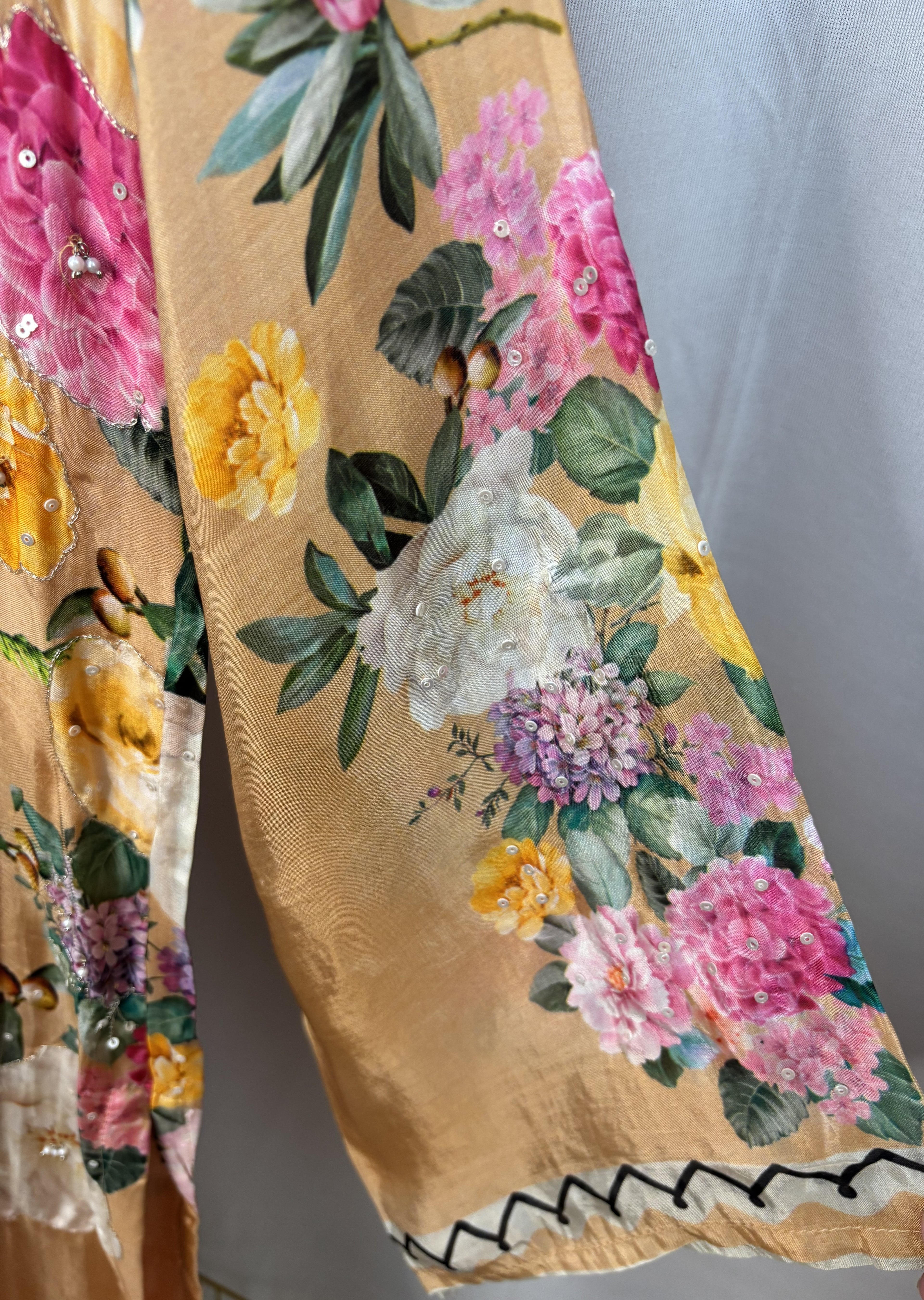 Floral patterned fabric with colorful flowers on a beige background