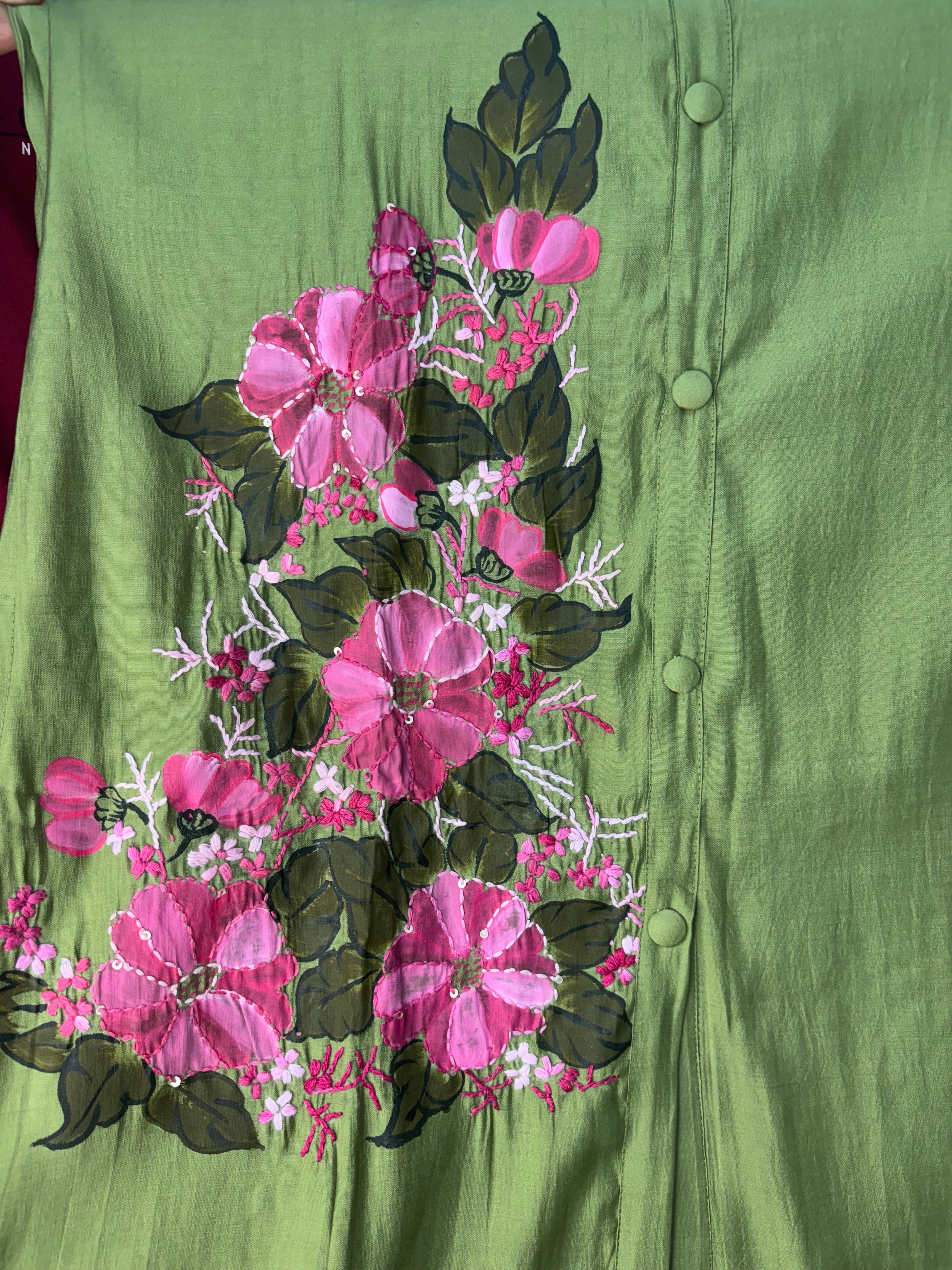 Floral embroidery on a green fabric background