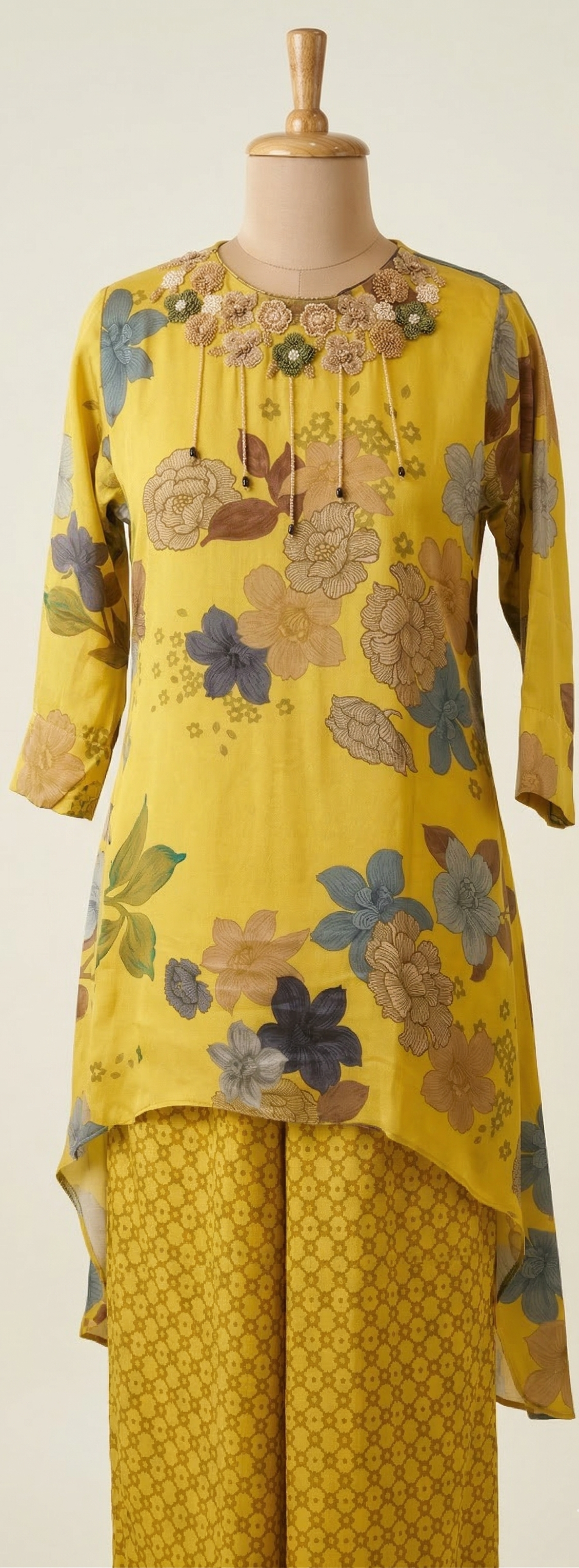 Yellow floral outfit on a mannequin against a white background