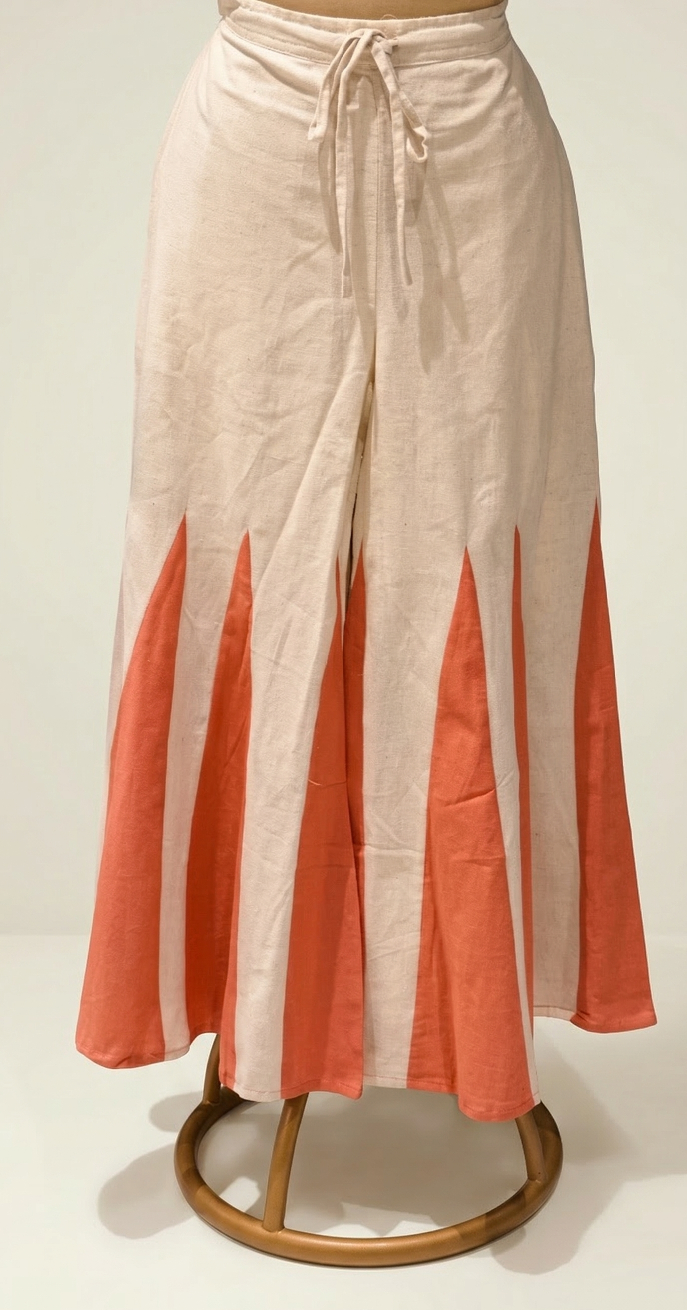 Beige and coral pants on a white background