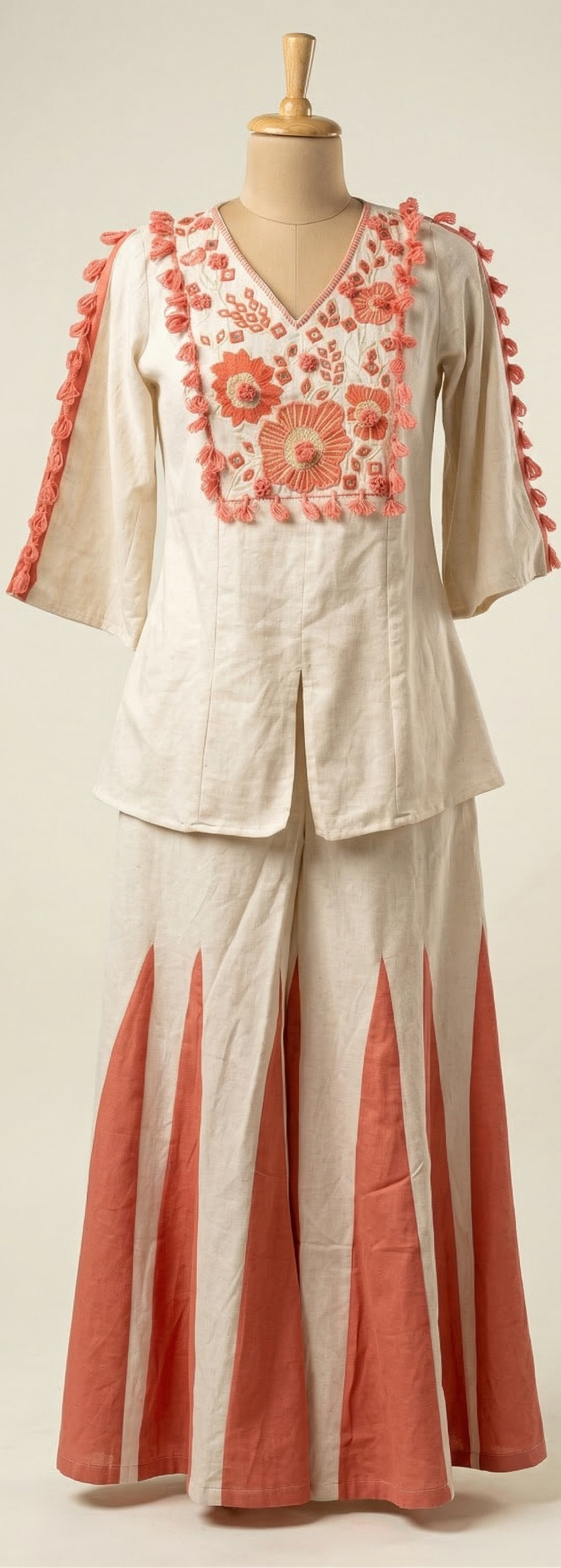 Two-piece outfit with floral embroidery on a mannequin against a white background