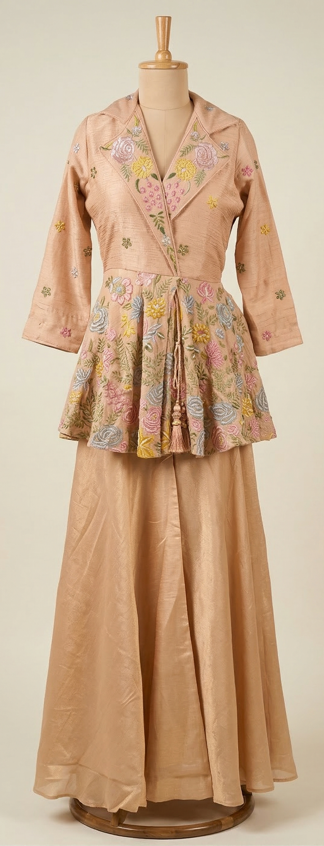 Vintage two-piece outfit with floral top and long skirt on a mannequin against a plain background